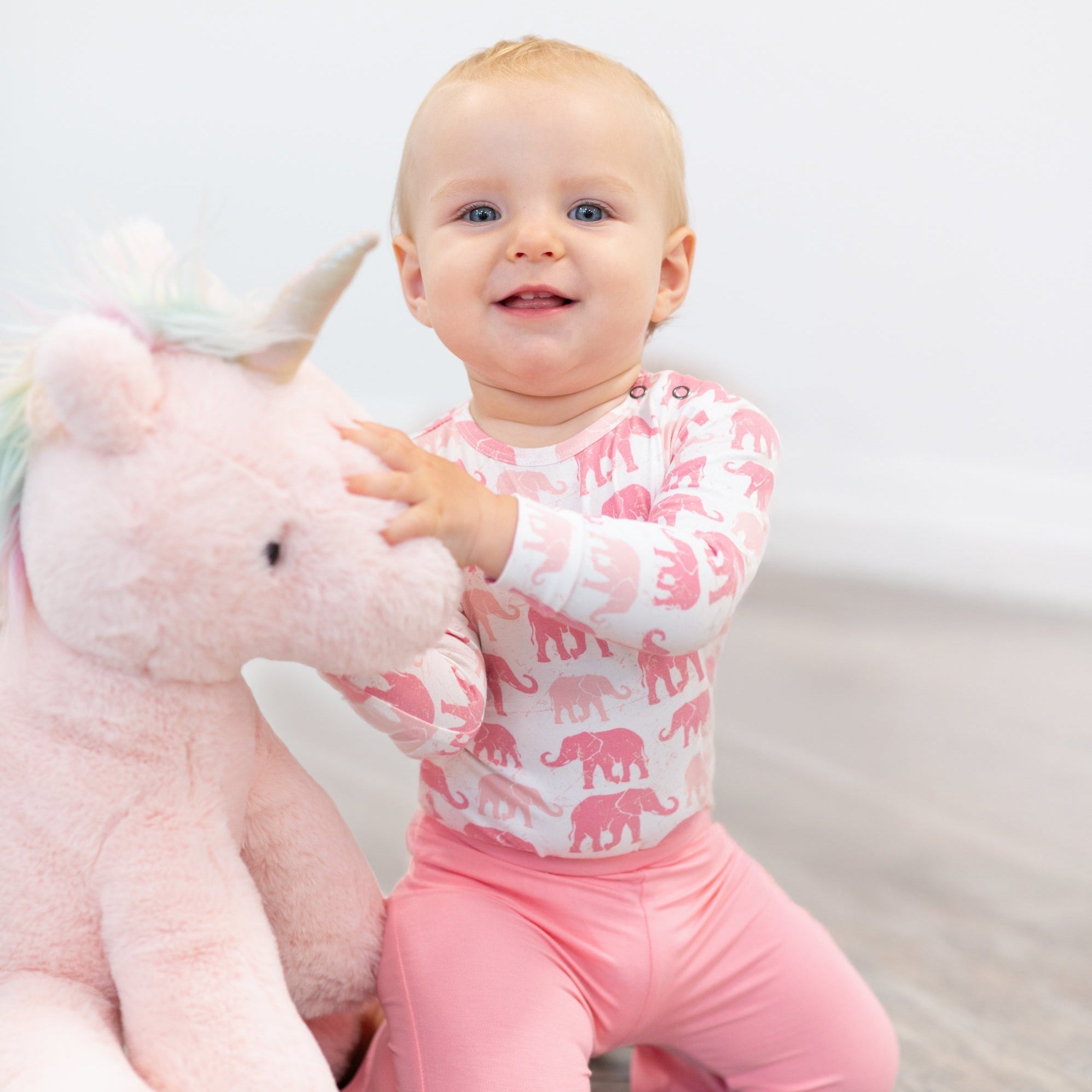 Girl’s candy pink flare leggings shown from the front, with elastic waistband and bell bottoms