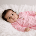 Pink long-sleeve ruffle gown with buttons, worn by a child