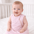 Pink sleeveless baby sleep sack on a girl, with front zipper