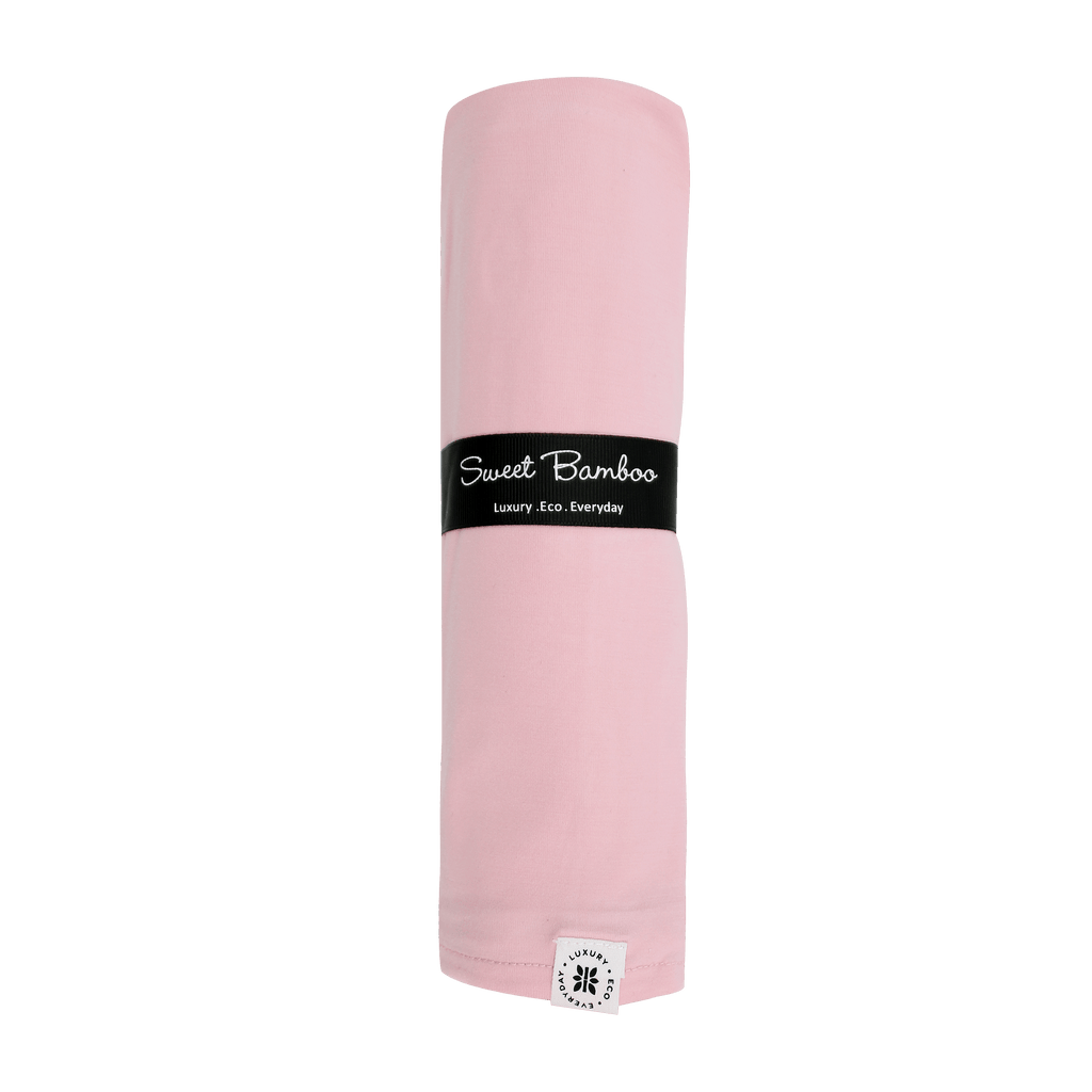 Pink swaddle blanket rolled bundle with black logo band and fabric end tag.