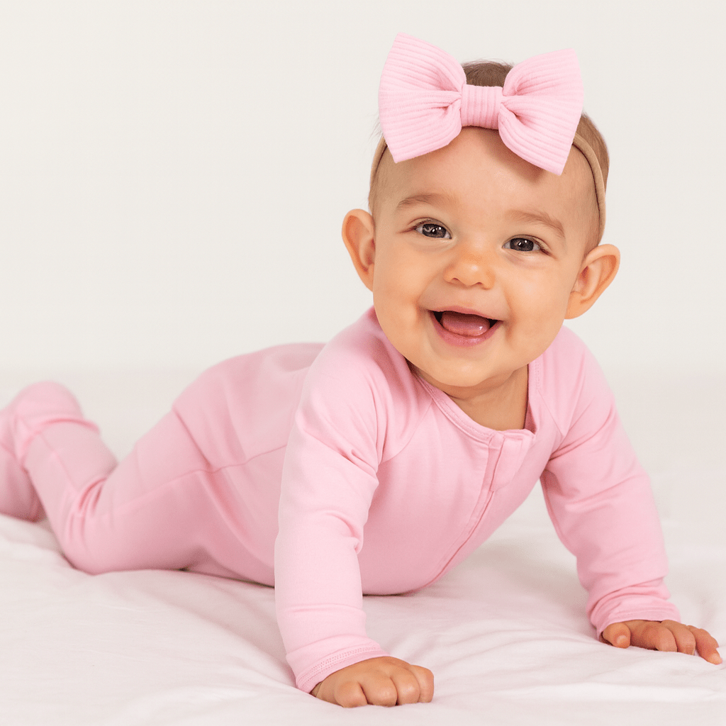 Candy pink zipper footie on baby, long sleeves and full-length zip front