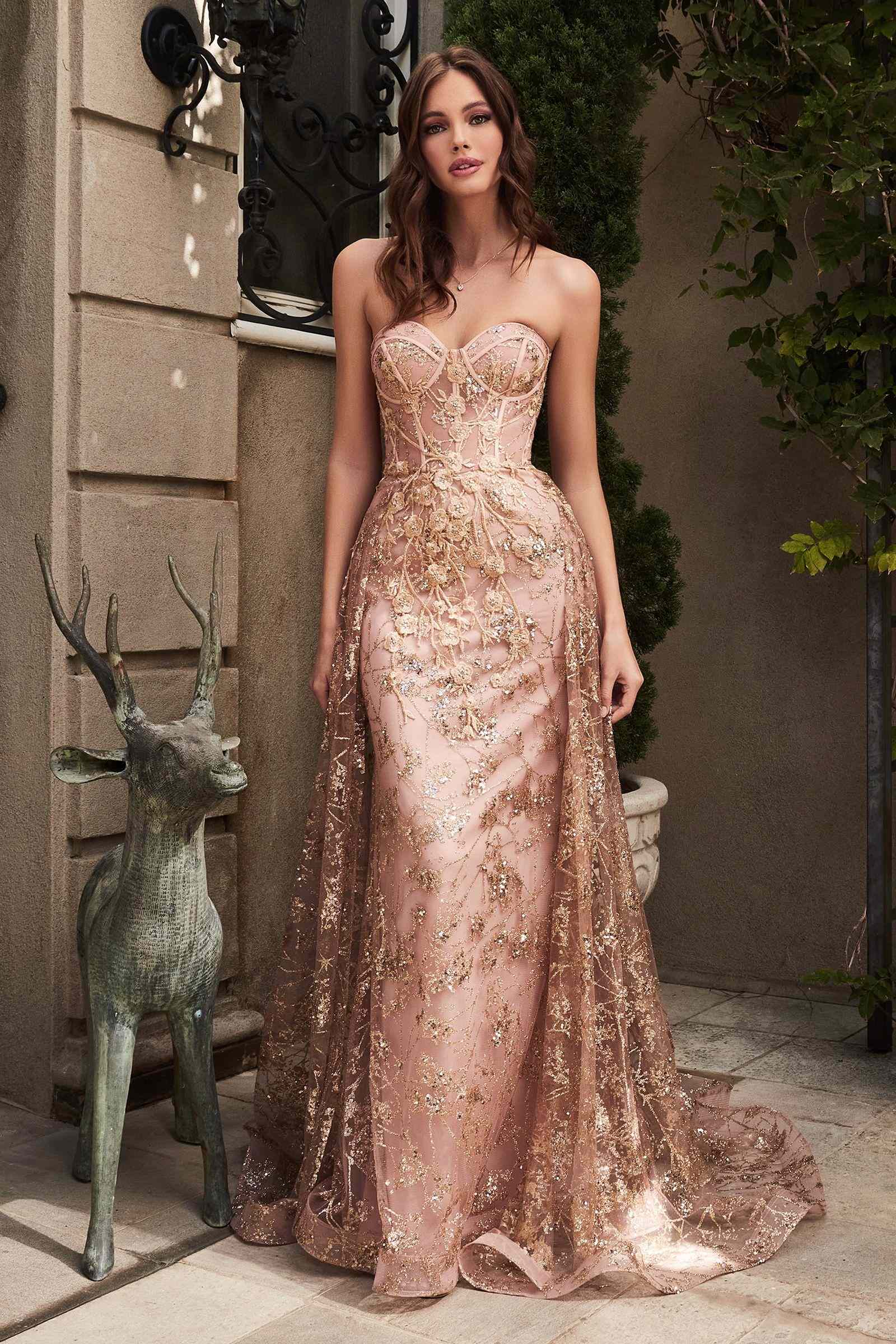 Champagne-gold strapless fitted gown with lace-like embroidery, glitter finish, and tulle skirt overlay