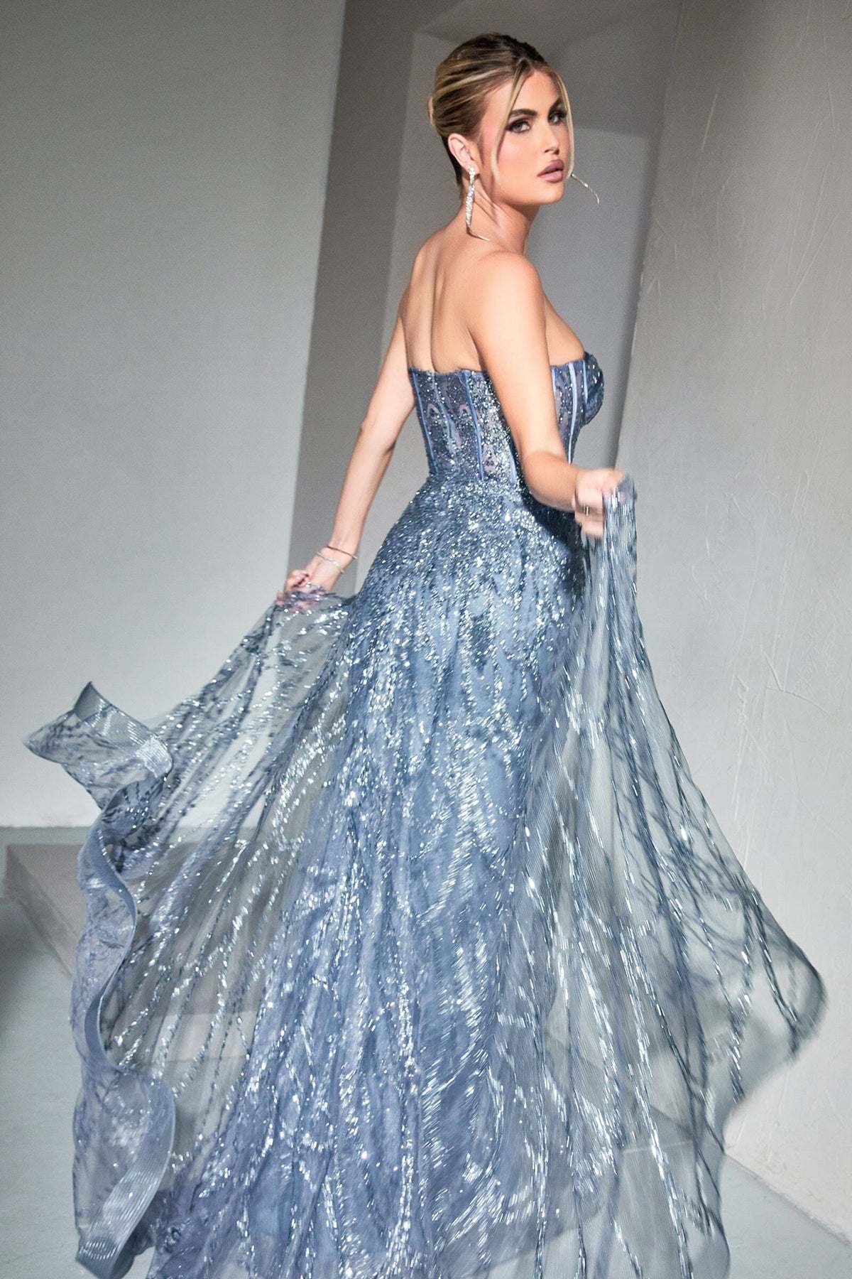 Blue strapless corset gown with shimmering lace overlay and flowing full skirt