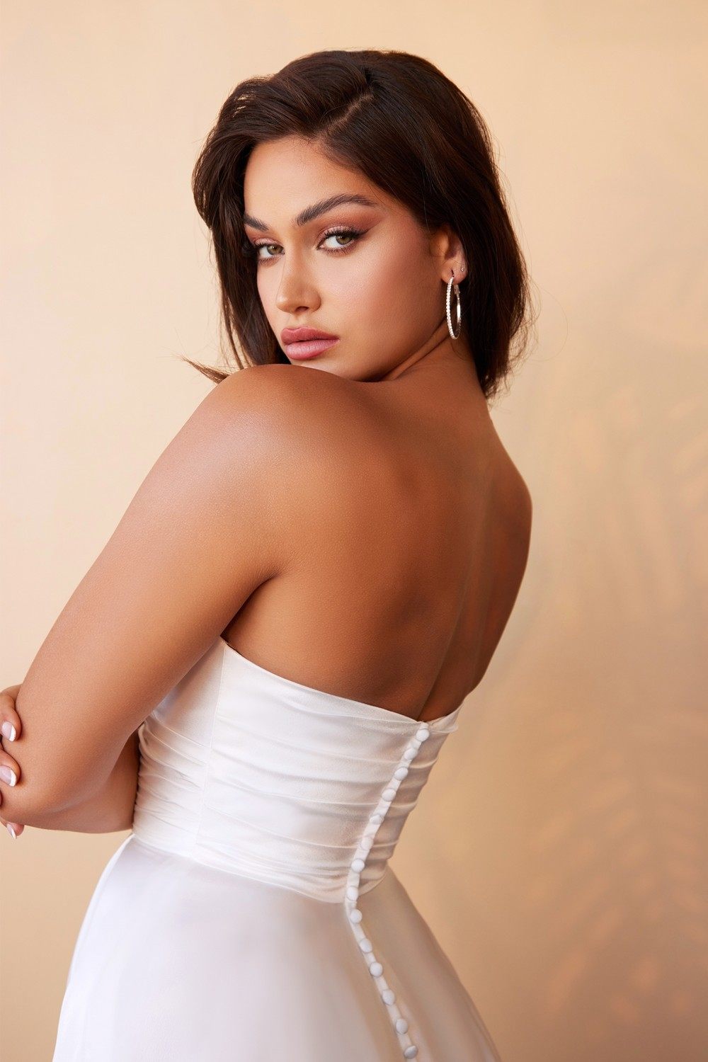 Off-white satin strapless back with draped detail and light beaded trim