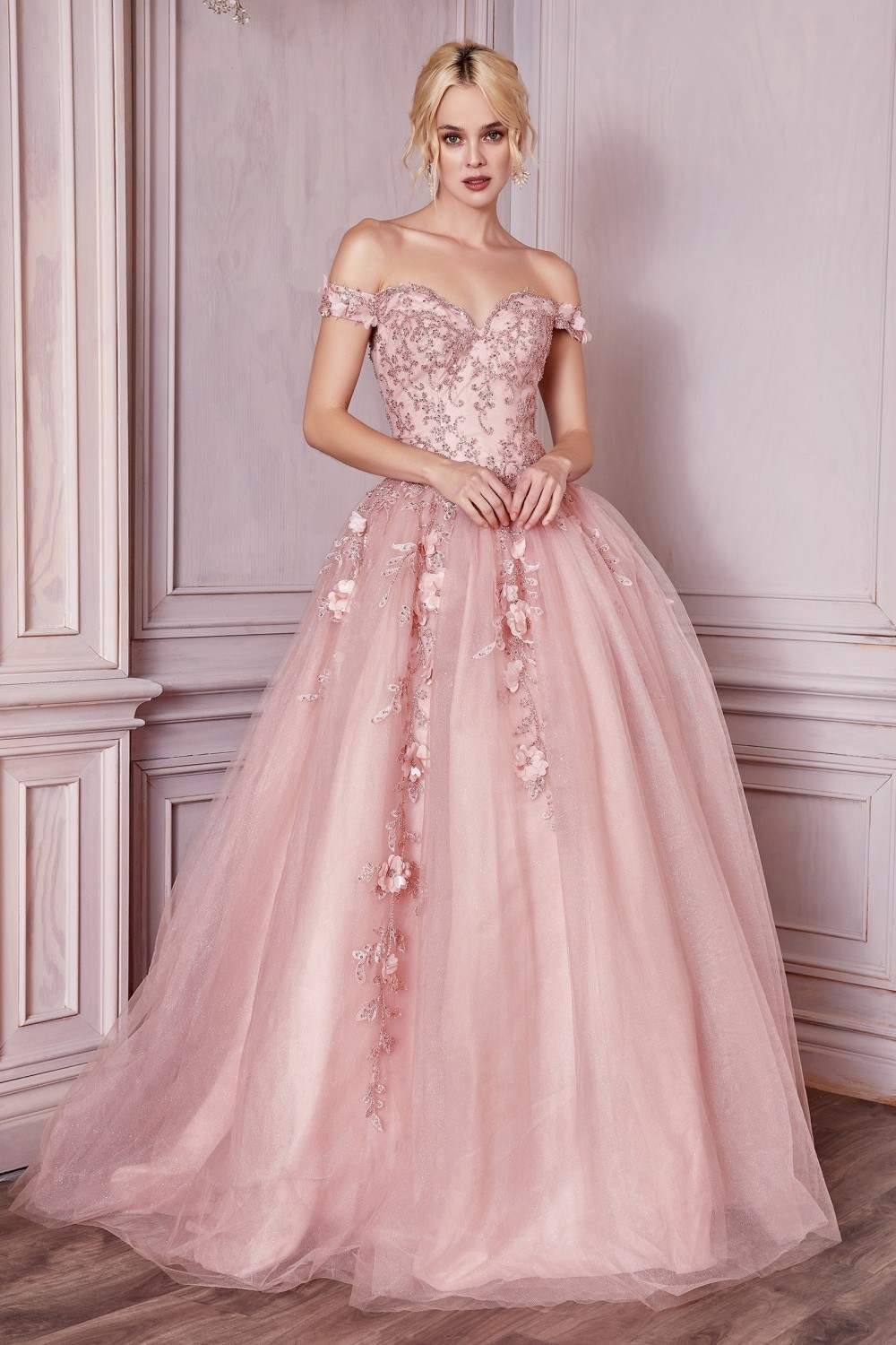 Off-shoulder layered tulle ball gown in blush pink with textured bodice and floral accents