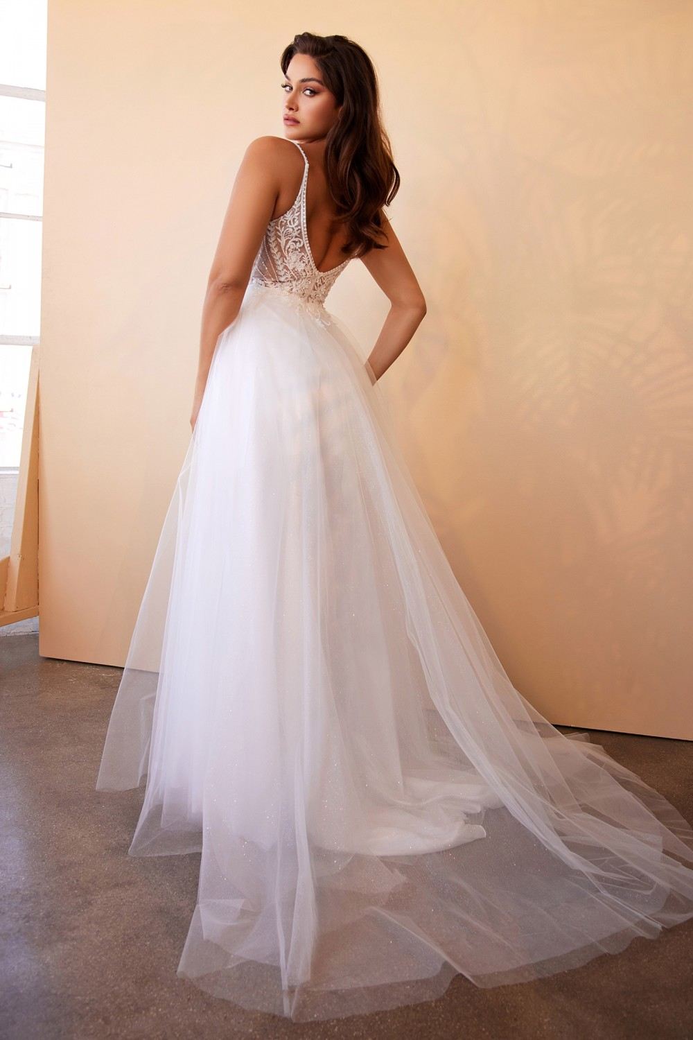 Off-white A-line bridal gown with lace-up back detail and layered tulle skirt