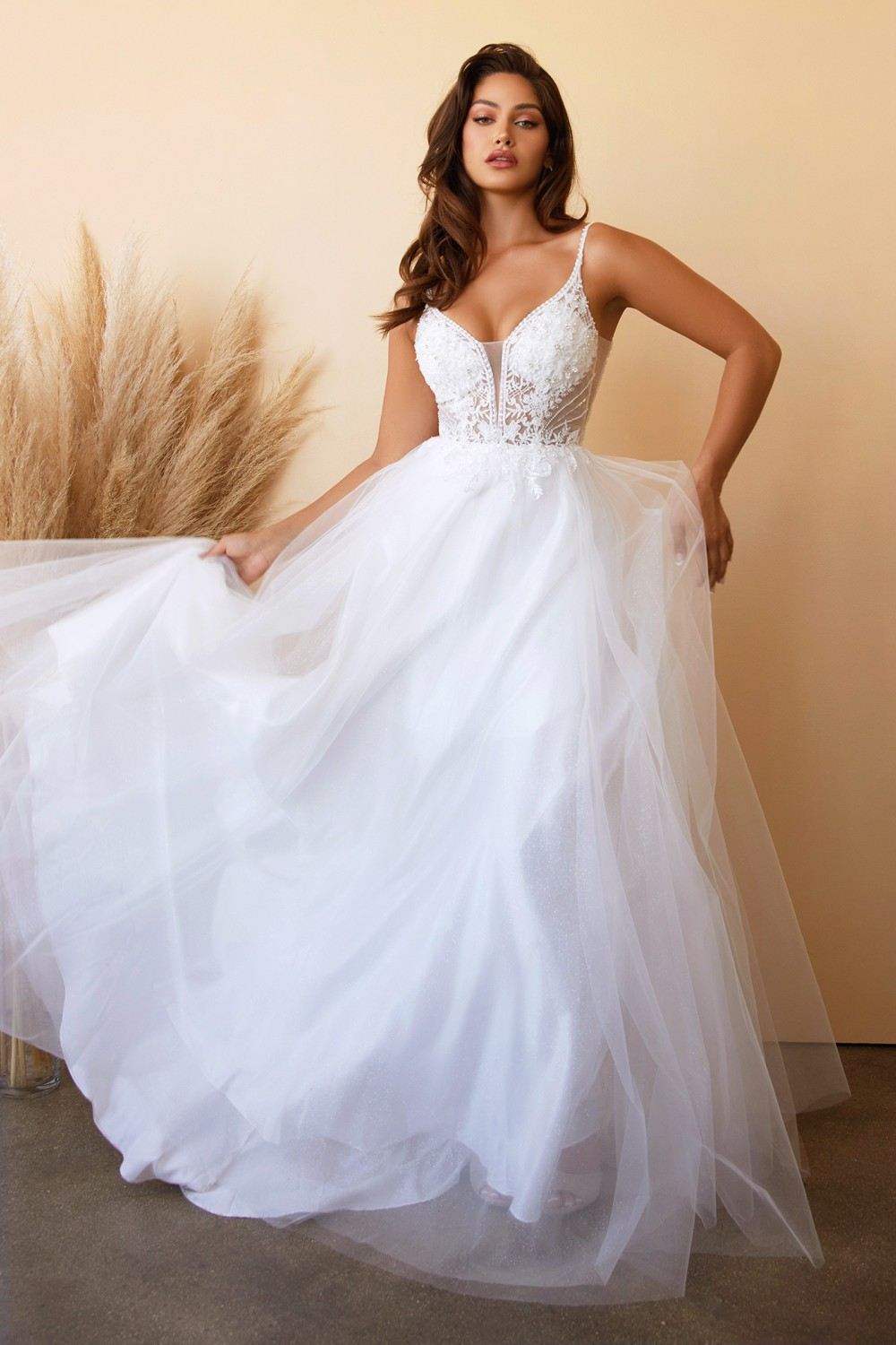 Off-white layered tulle A-line bridal gown with lace V-neck bodice and voluminous skirt