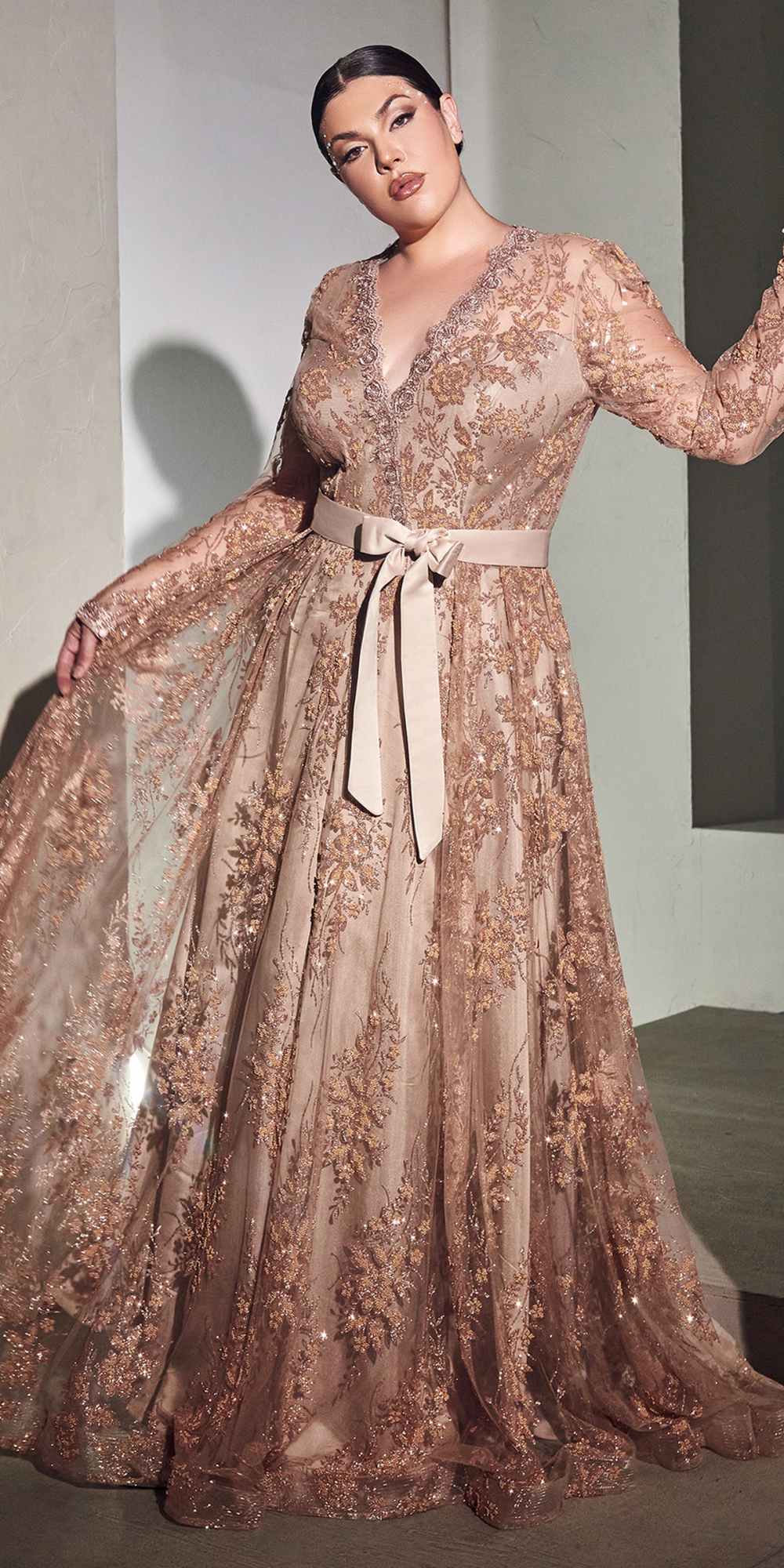 Champagne gold long-sleeve embellished ball gown with V-neck and waist sash bow