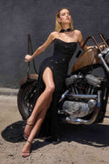 Strapless evening gown in black with sparkling texture, high slit, and fitted mermaid shape