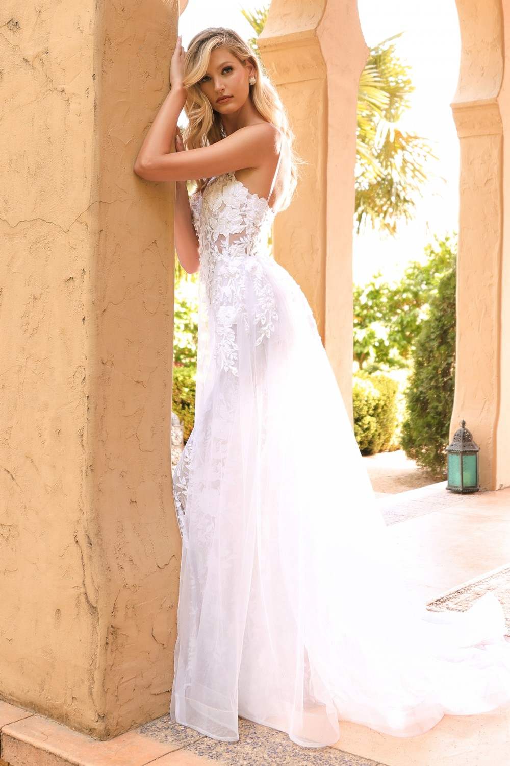 Off-white lace wedding gown with sheer overlay, fitted bodice and long A-line skirt