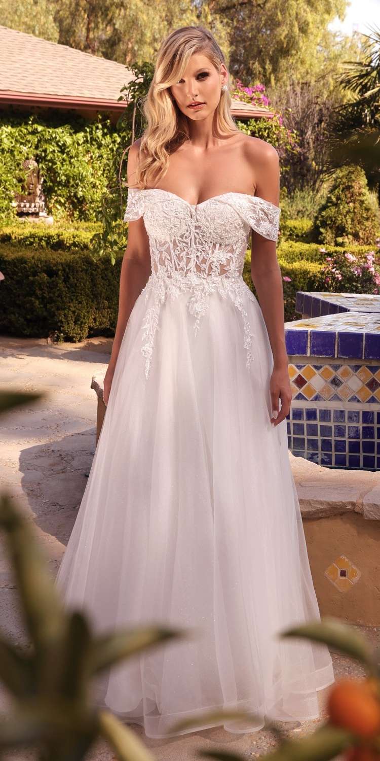 Off-white off-shoulder lace bridal gown with fitted bodice and flowing tulle skirt