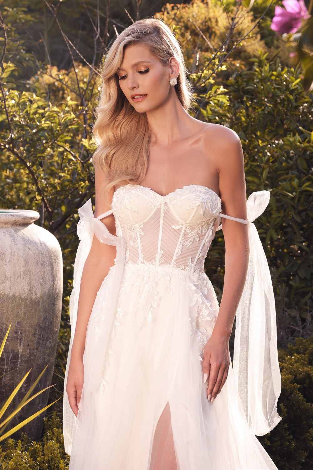 Off-white lace sweetheart wedding gown with boned bodice and draped ribbon shoulder ties
