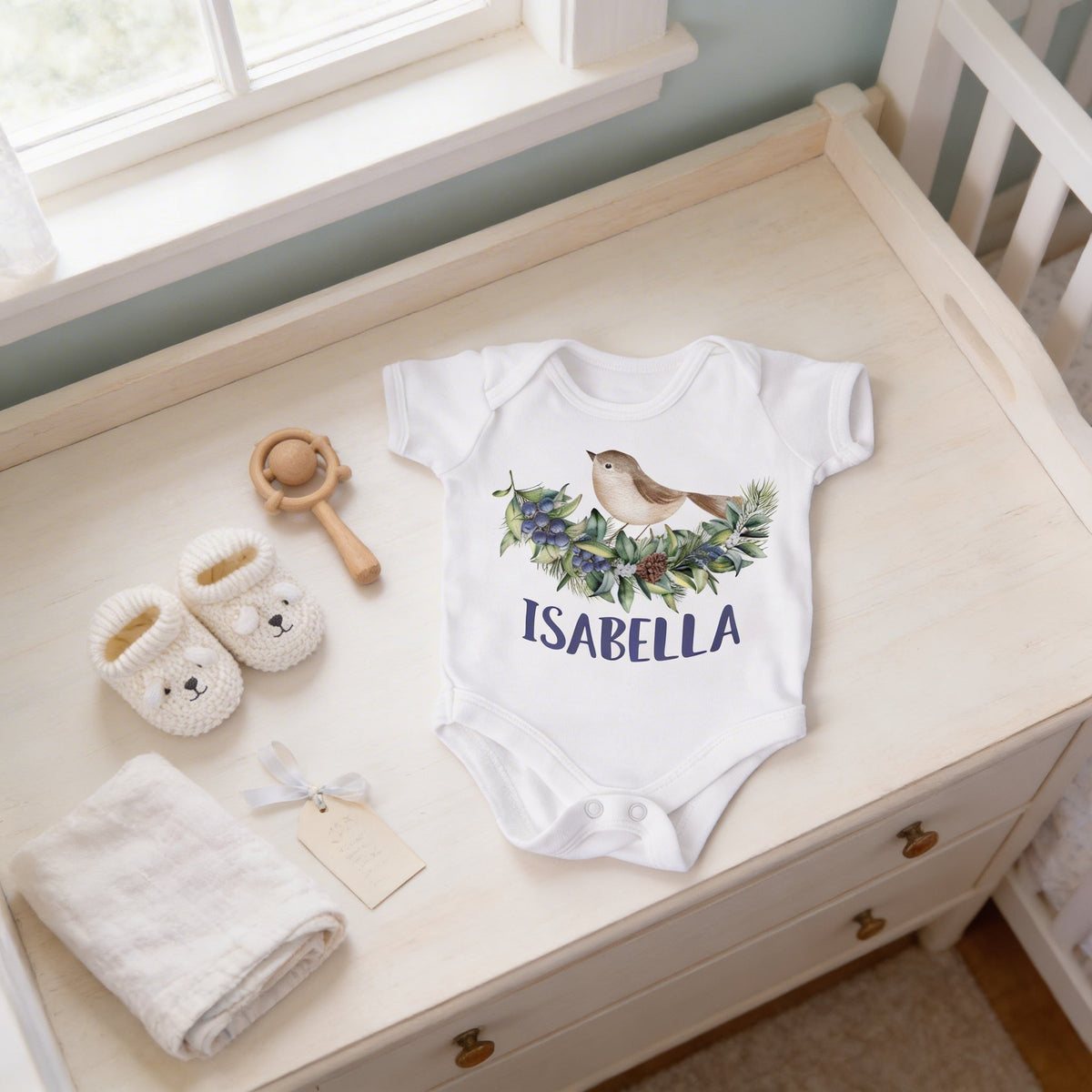 White infant baby bodysuit with bird-and-leaf wreath design and 'ISABELLA' front print