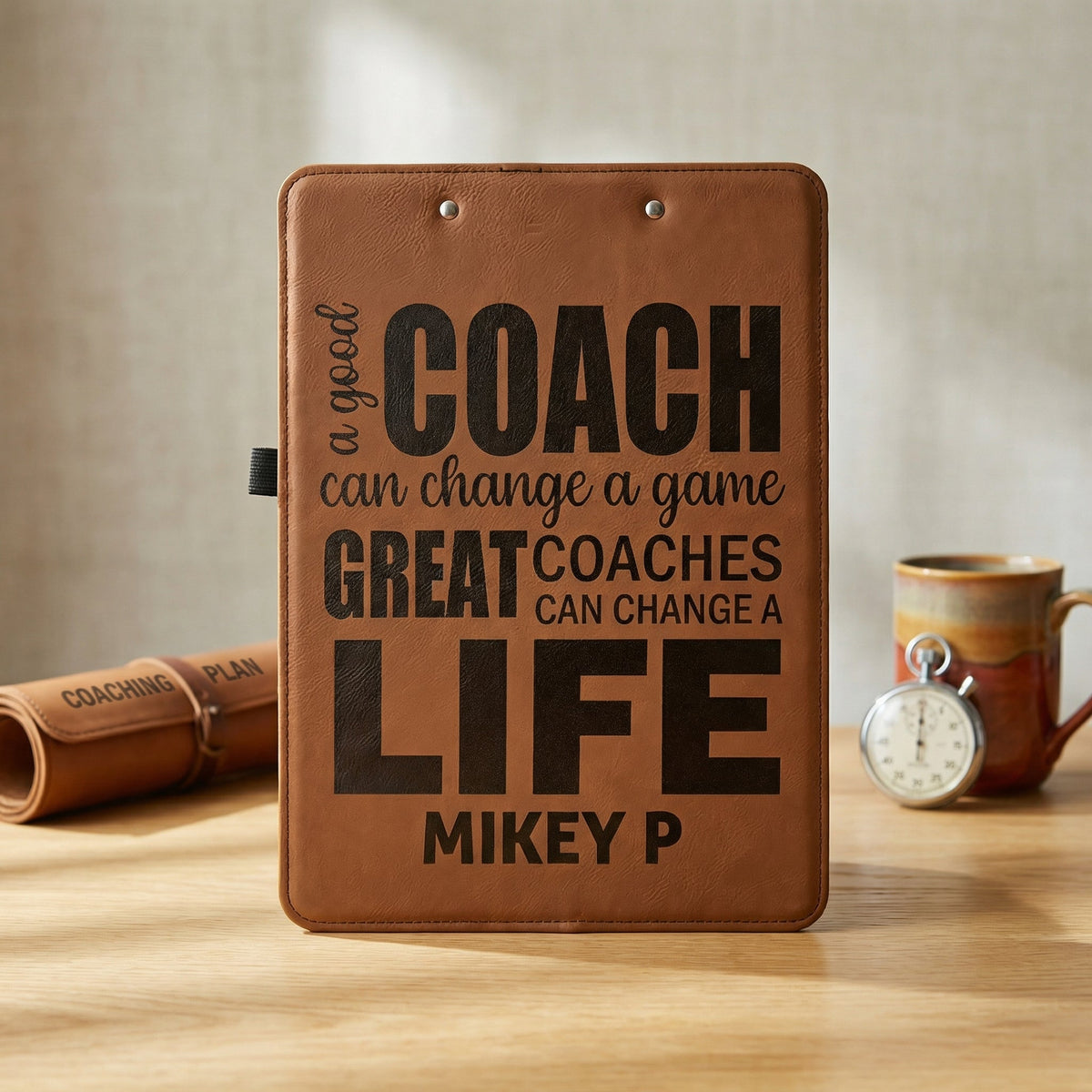 Brown leather clipboard with metal clip and coach life quote panel