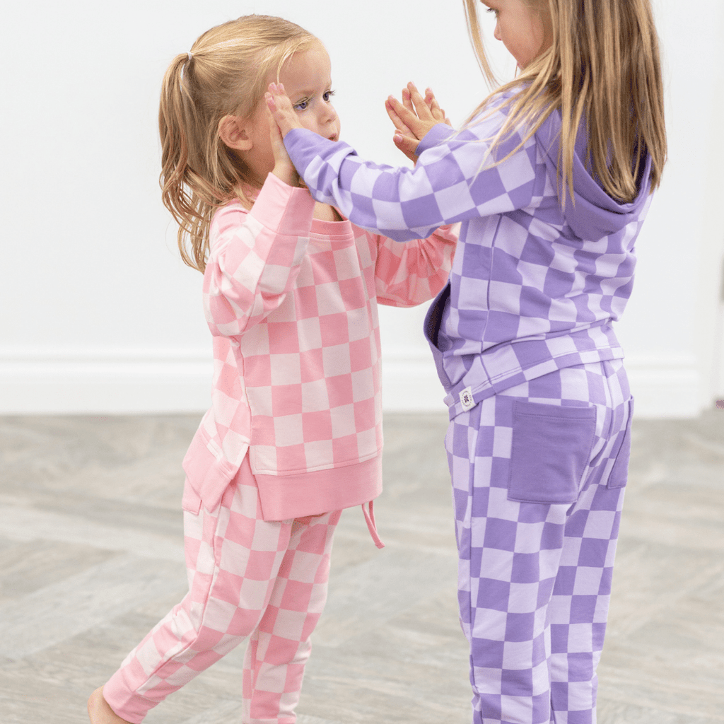 Pink checkered baby jogger set with long-sleeve crew top and relaxed jogger pants