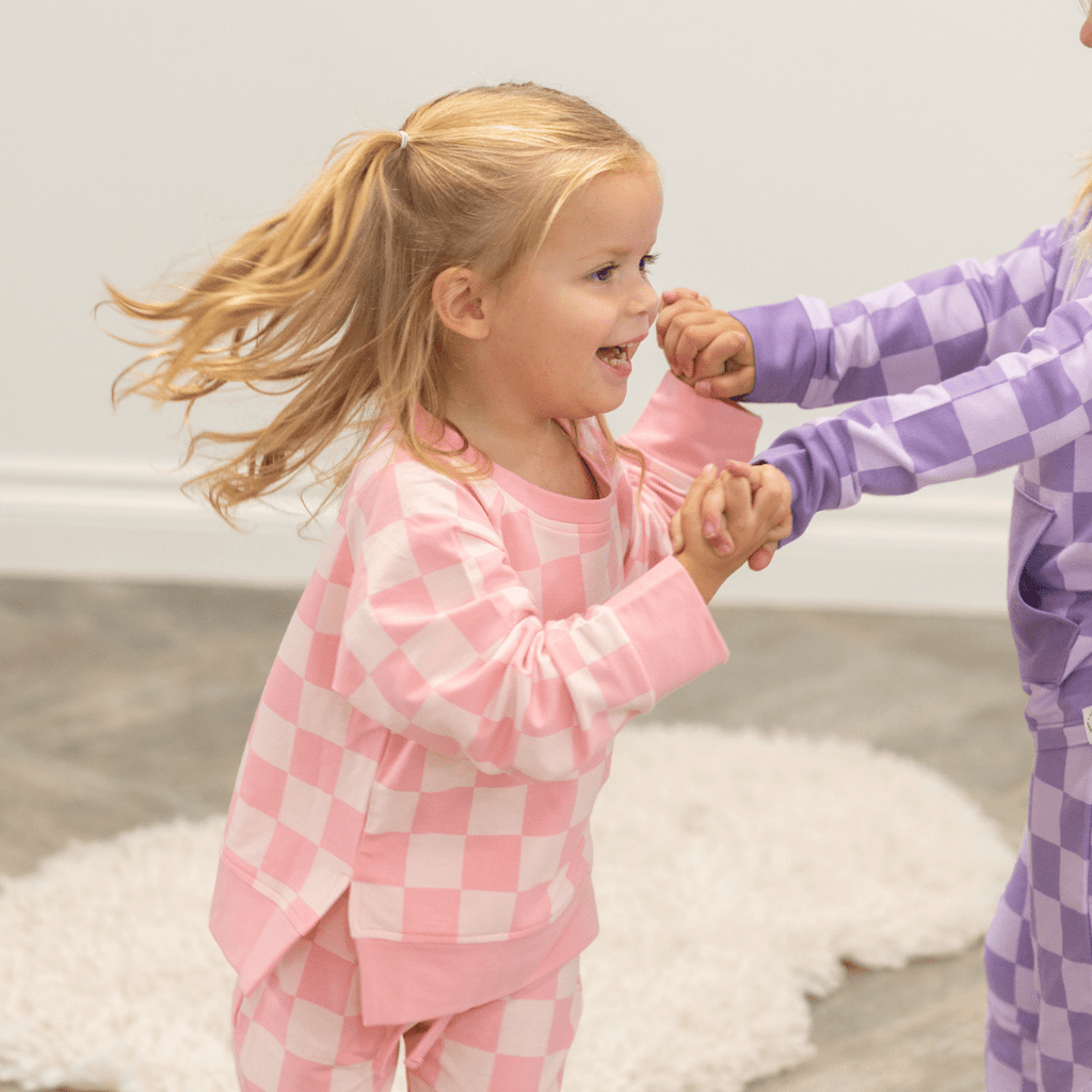 Pink checkered baby jogger set with long-sleeve crew top and cuffed pants