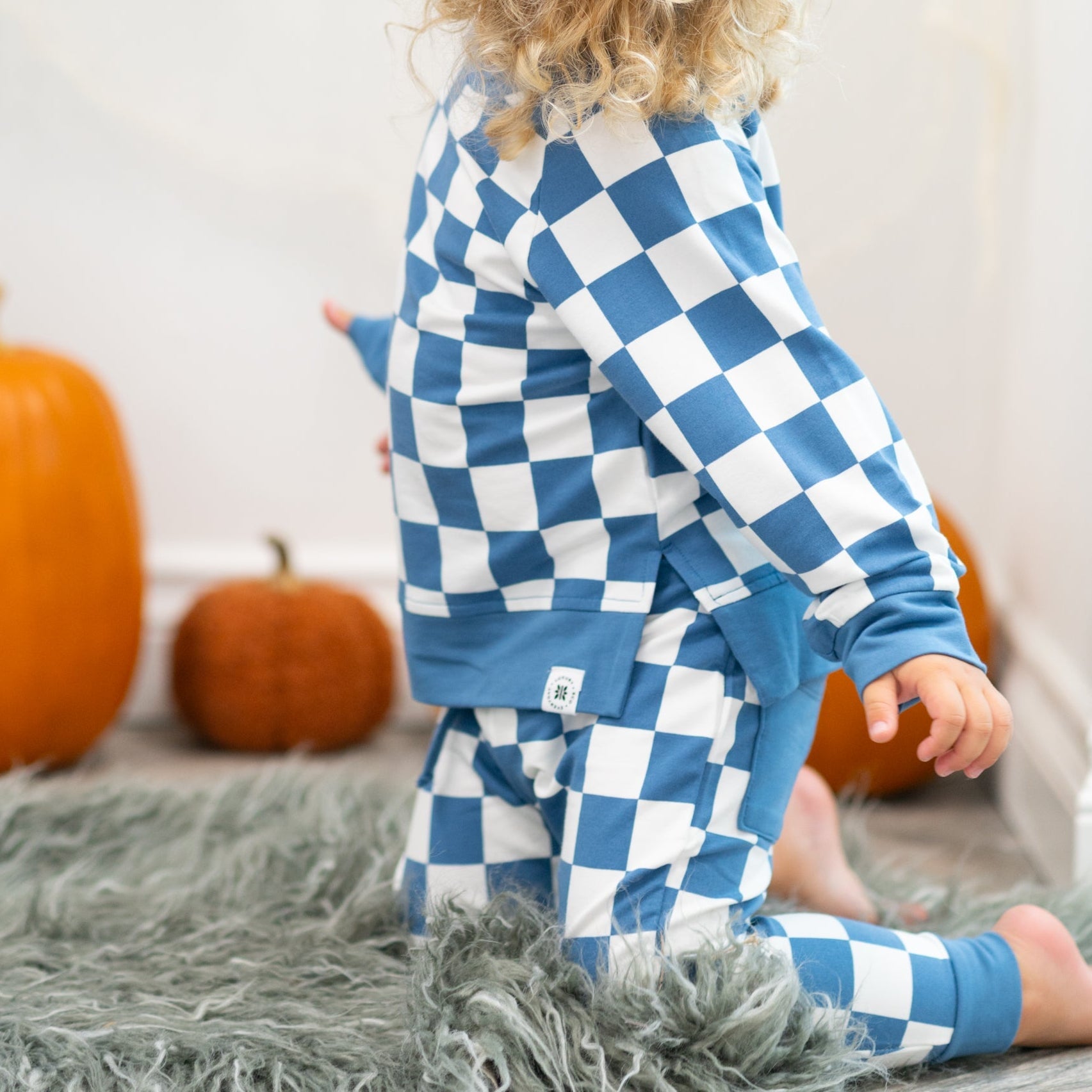 Blue and white checkered jogger set with crew neck top and matching pants (side view).