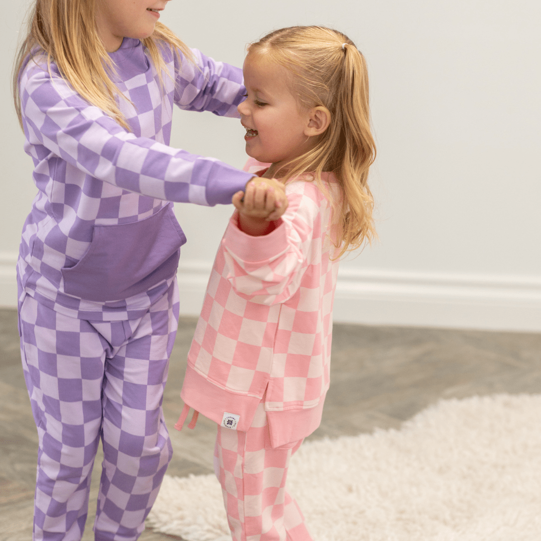 Purple checker crew neck sweatshirt and jogger pants set, worn with ribbed cuffs.