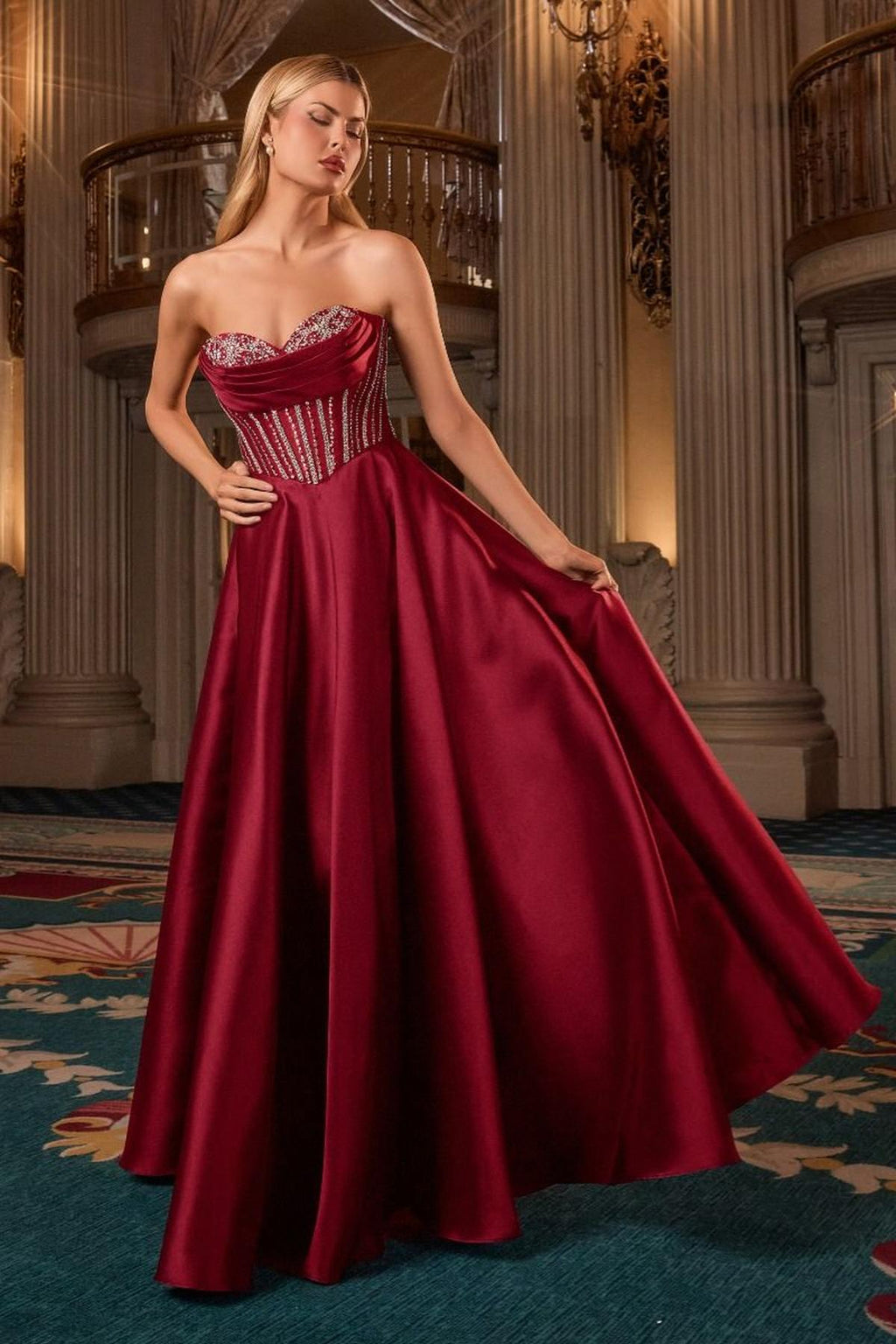 Burgundy strapless sweetheart ball gown with corset bodice and full flared skirt