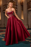 Burgundy strapless sweetheart ball gown with corset bodice and full flared skirt