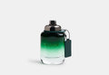 Coach for Men green eau de toilette bottle with green glass, black cap, and hanging tag