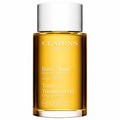 Clarins Tonic treatment oil bottle with amber glass and white cap
