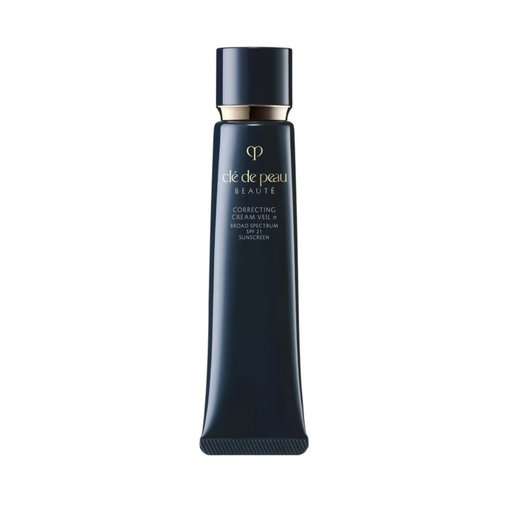 Correcting cream veil SPF25 bottle with gold cap and dark navy body