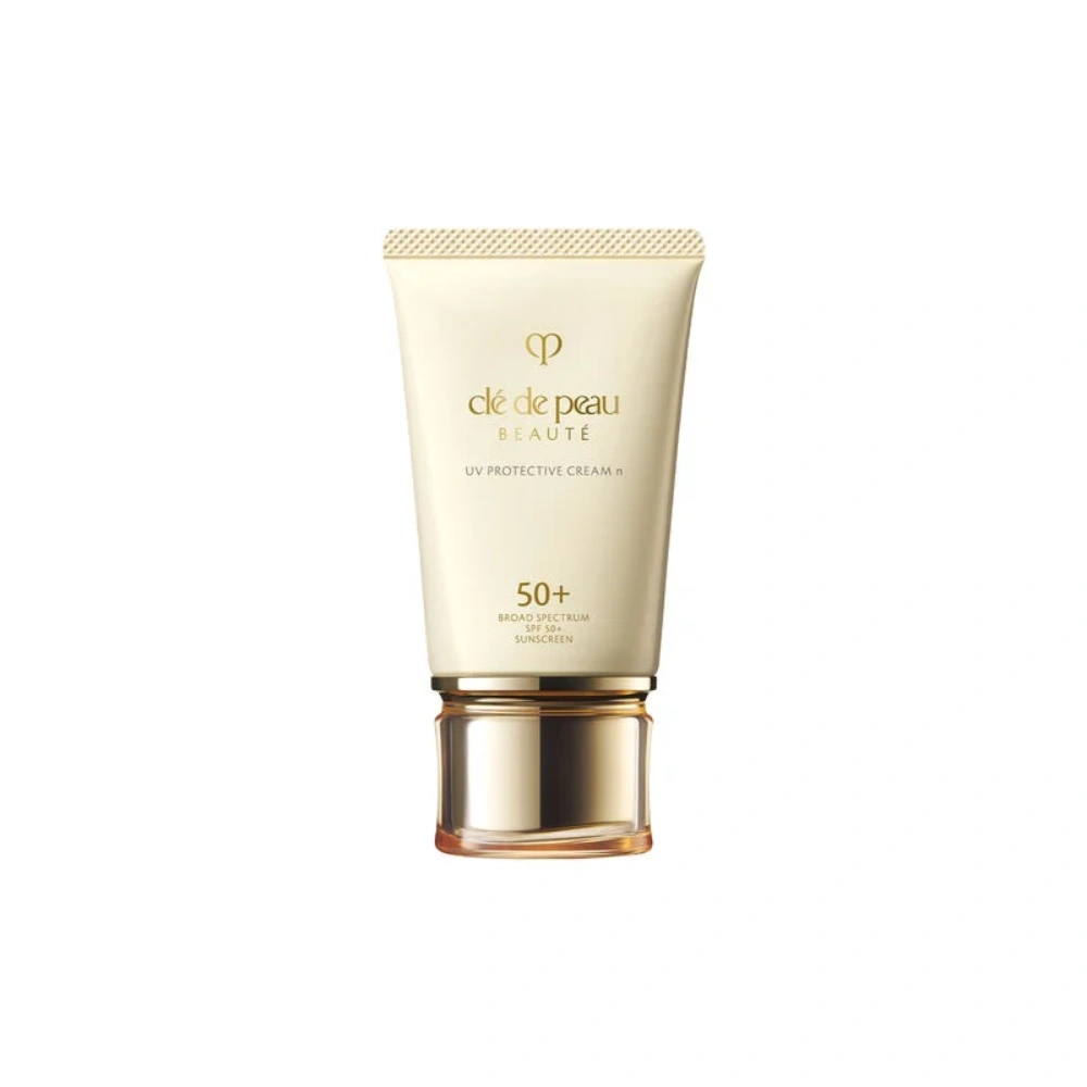 UV protective cream tube, beige with gold base and cap, SPF 50+.