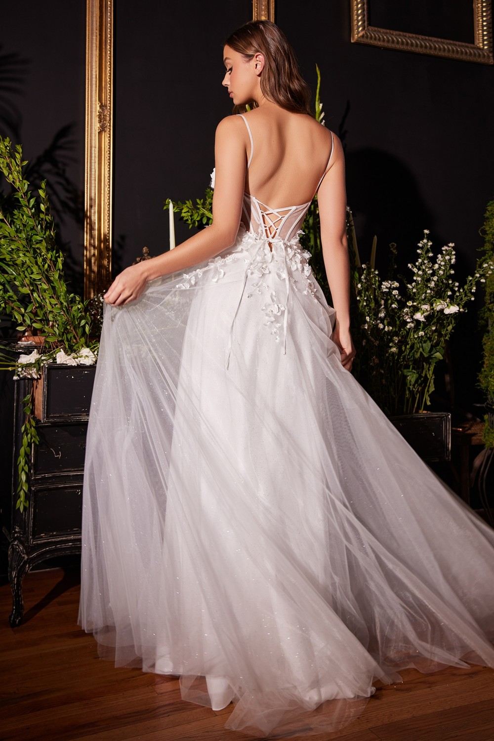 Off-white tulle A-line bridal gown with open back and floral applique straps