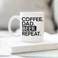 White ceramic coffee mug with COFFEE DAD BEER REPEAT text, handle on left