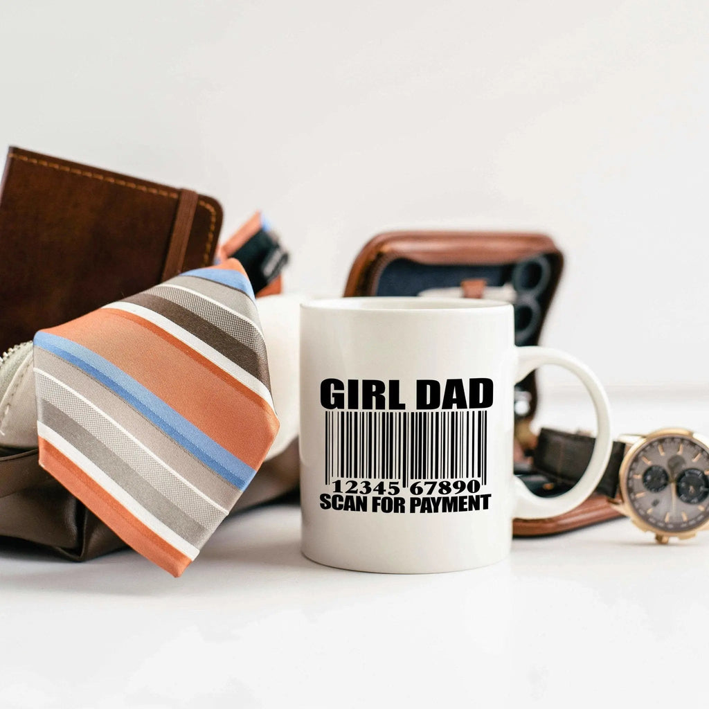White ceramic coffee mug with 'GIRL DAD' text and barcode, studio side view