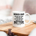 White ceramic coffee mug with BONUS-DAD quote, black lettering