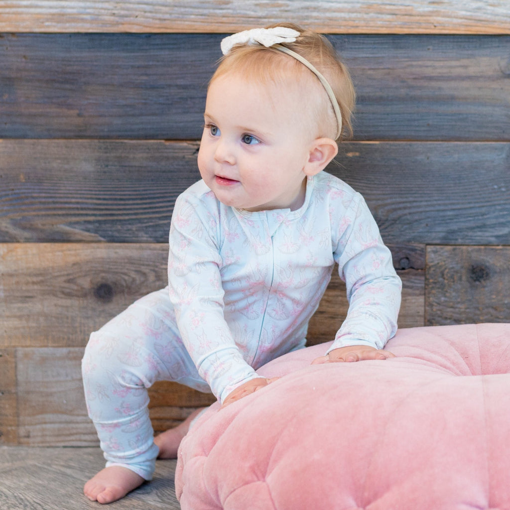 Light blue swan-print long-sleeve baby romper, footed legs, front snaps