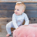 Light blue swan-print long-sleeve baby romper, footed legs, front snaps