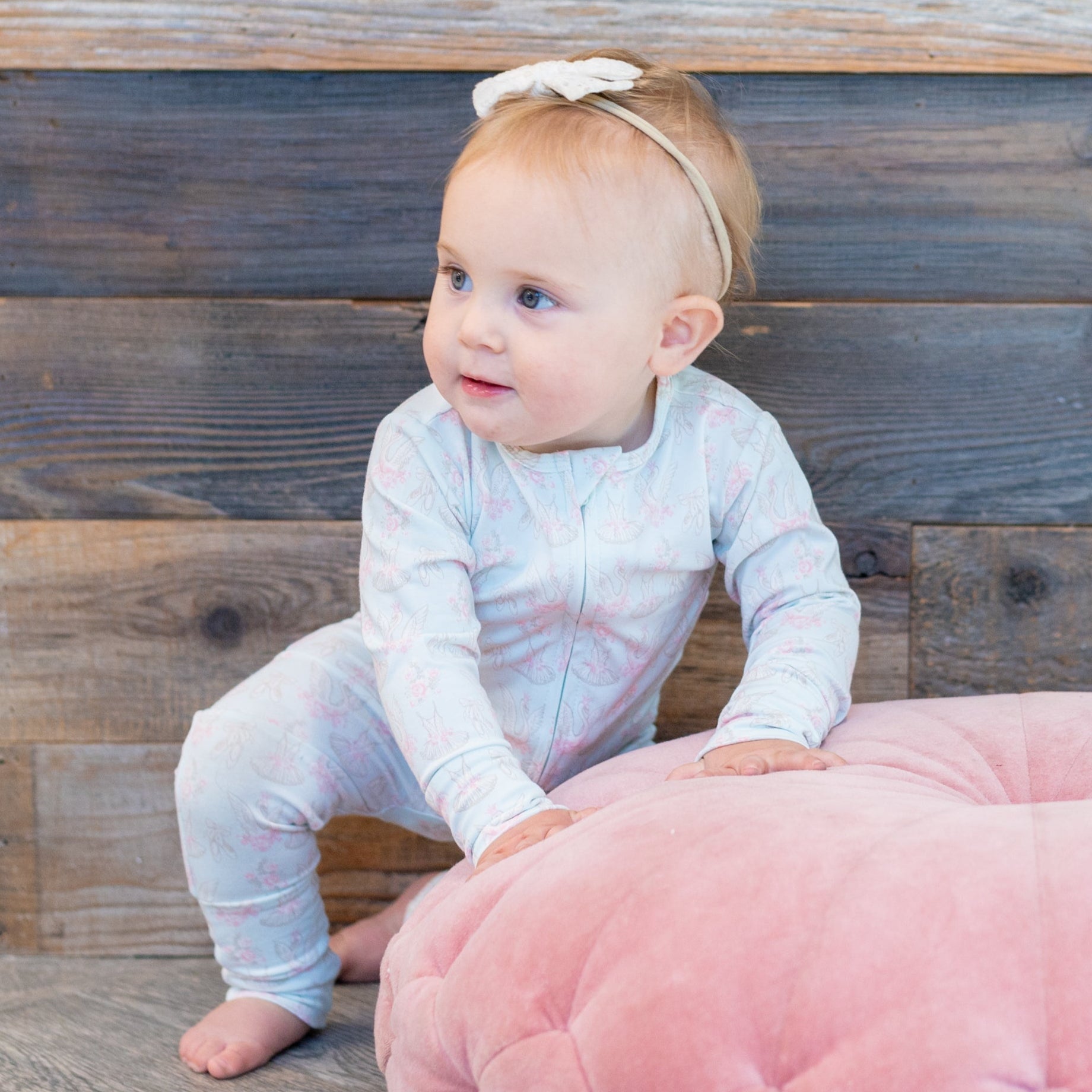 Light blue swan-print long-sleeve baby romper, footed legs, front snaps