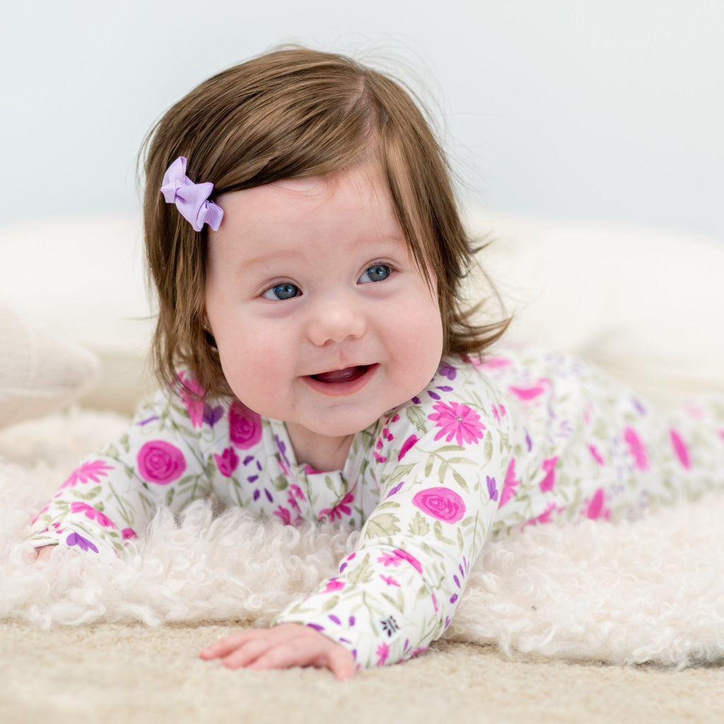 Baby girl floral long-sleeve romper in white with pink and purple blooms