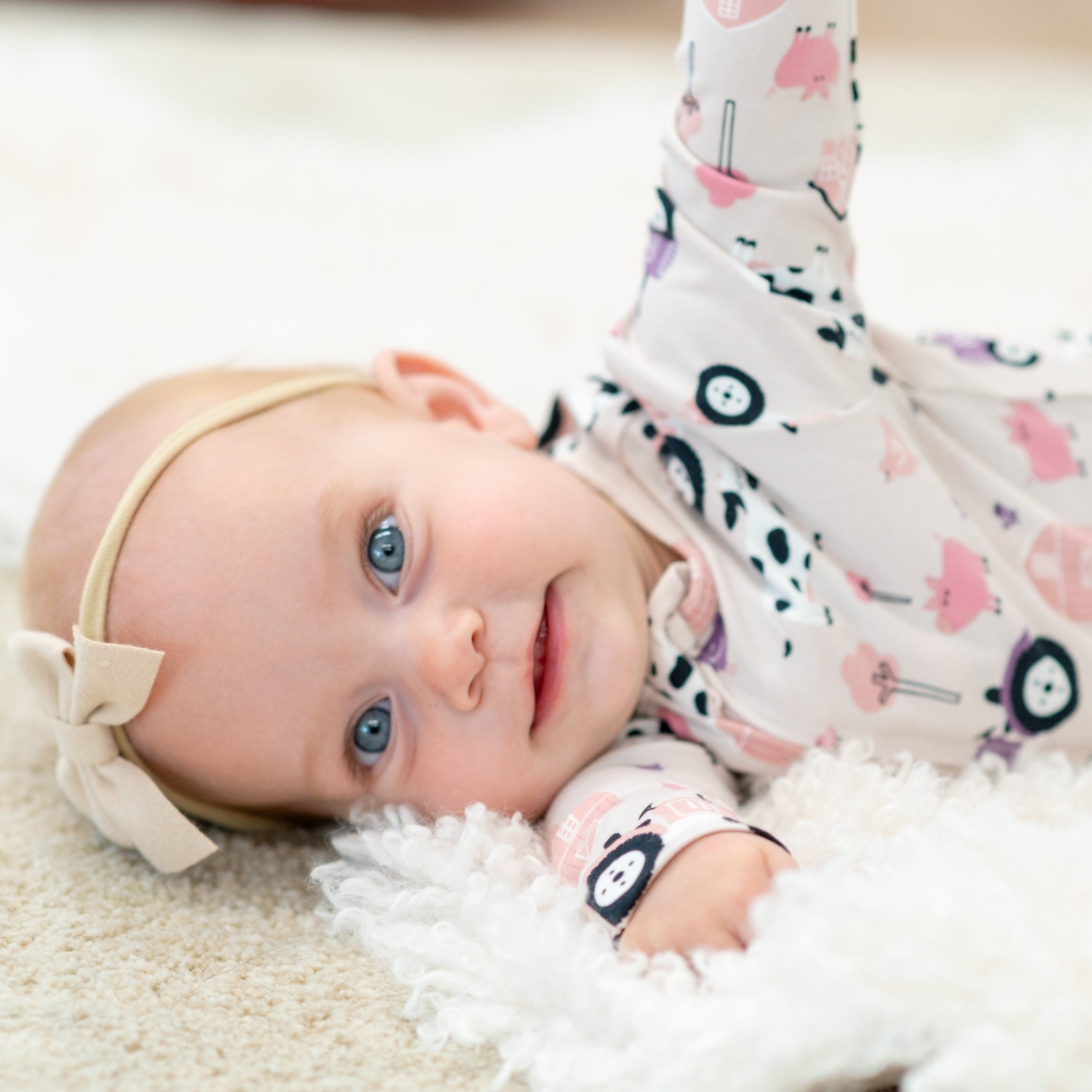 Baby girl farm print footie romper in light pink/white, long sleeves, allover tractors