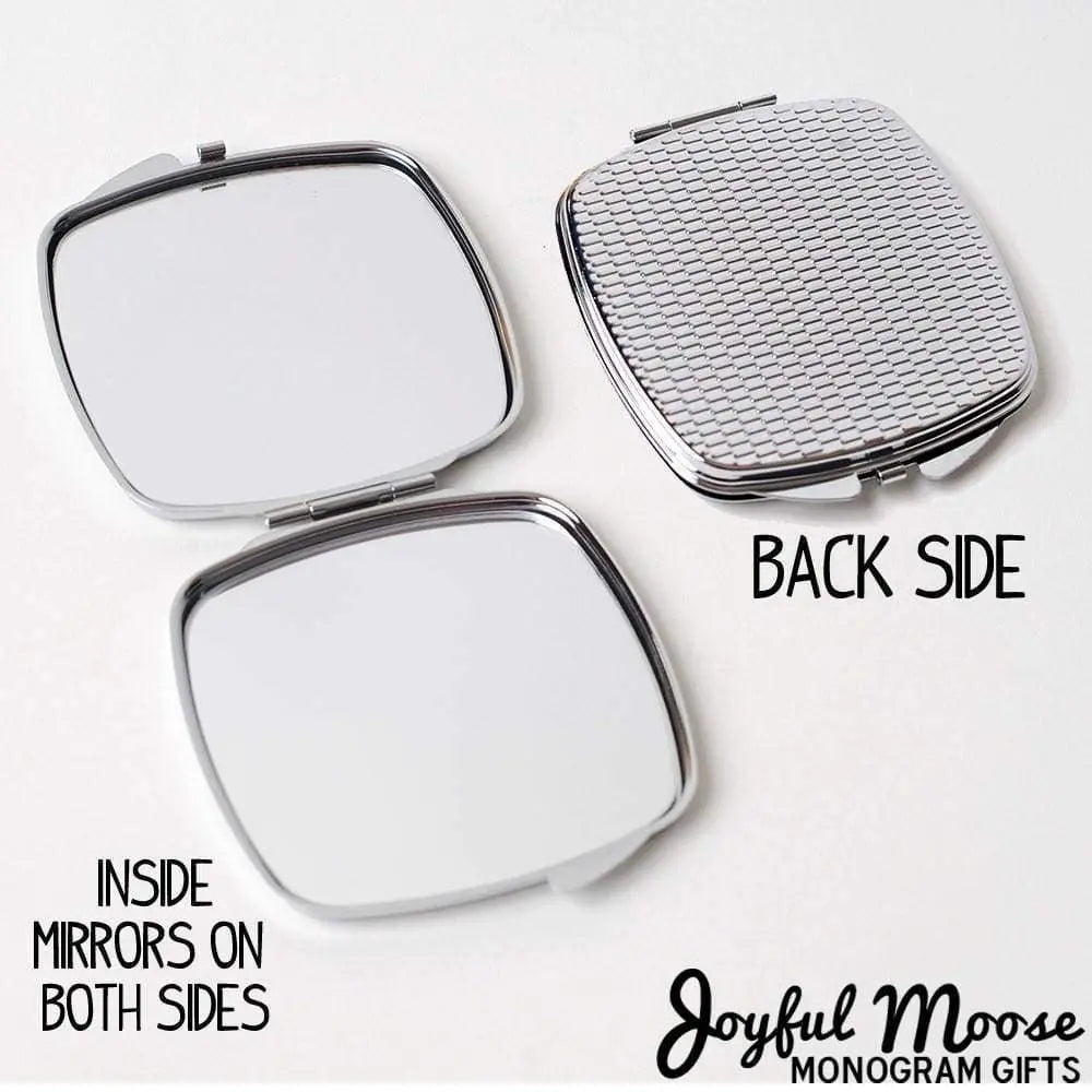 Compact mirror purse open to show two inside mirror panels and silver mesh back