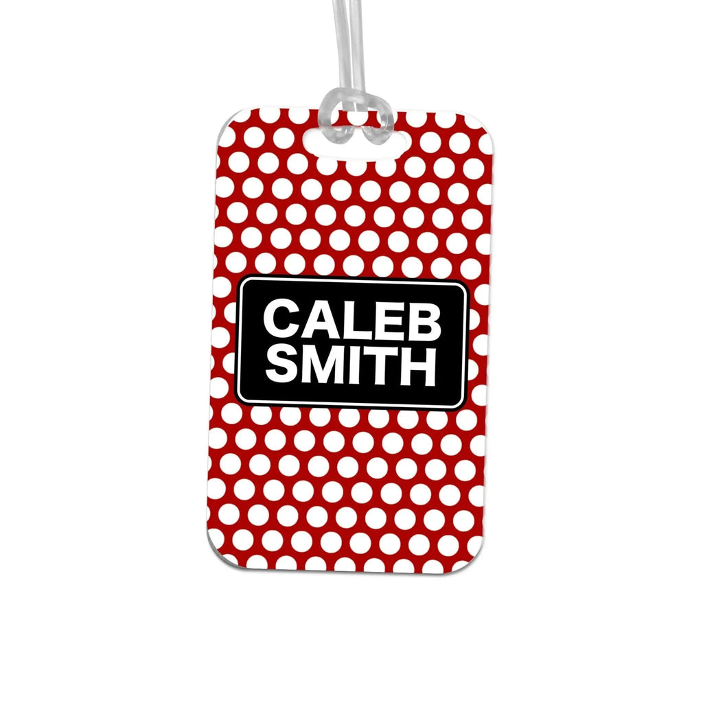 Red polka dot personalized bag tag with black name label reading CALEB SMITH