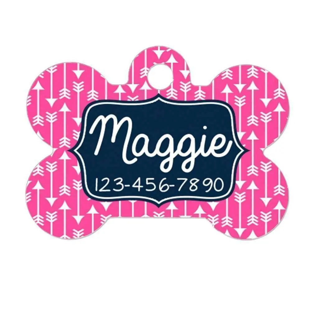 Bone-shaped pet ID tag with pink geometric pattern and navy center reading "Maggie" plus number