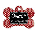 Bone-shaped pet ID tag with red quatrefoil pattern and black name plate, hole for ring