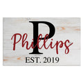 Rustic wooden wedding family name sign with red script, black initial P, and EST. 2019