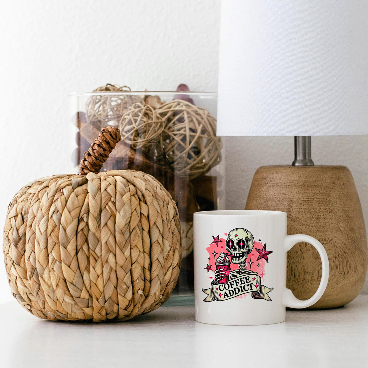 White ceramic coffee mug with pink skull 'Coffee Addict' graphic, small standing mug view