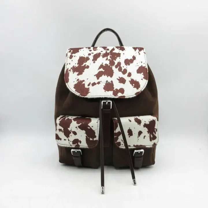 Brown cow print mini backpack handbag with top handle, front flap and two buckled pockets