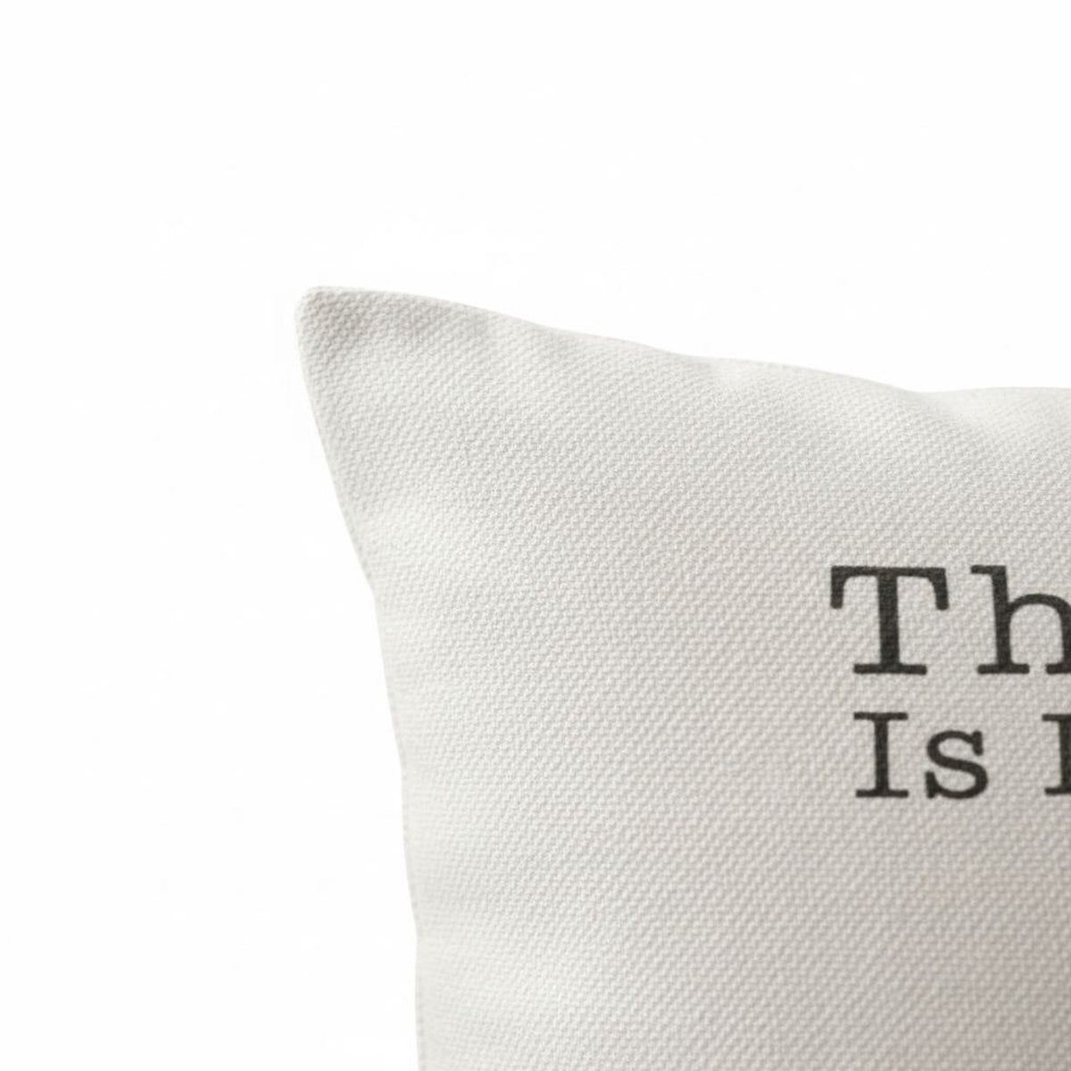 White textured pillow cover corner with partial printed paw-quote text