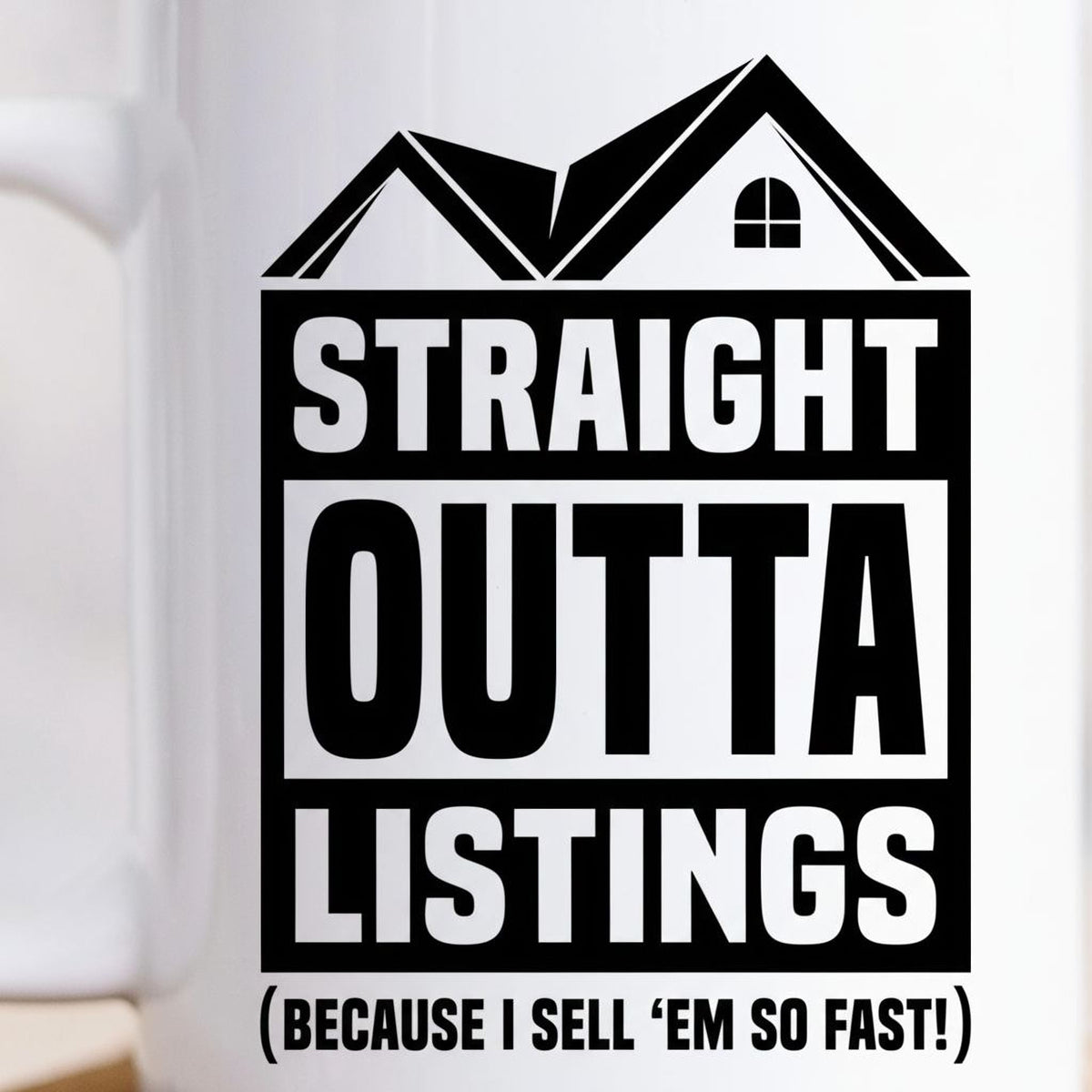 Close-up of white ceramic mug with black “STRAIGHT OUTTA LISTINGS” graphic