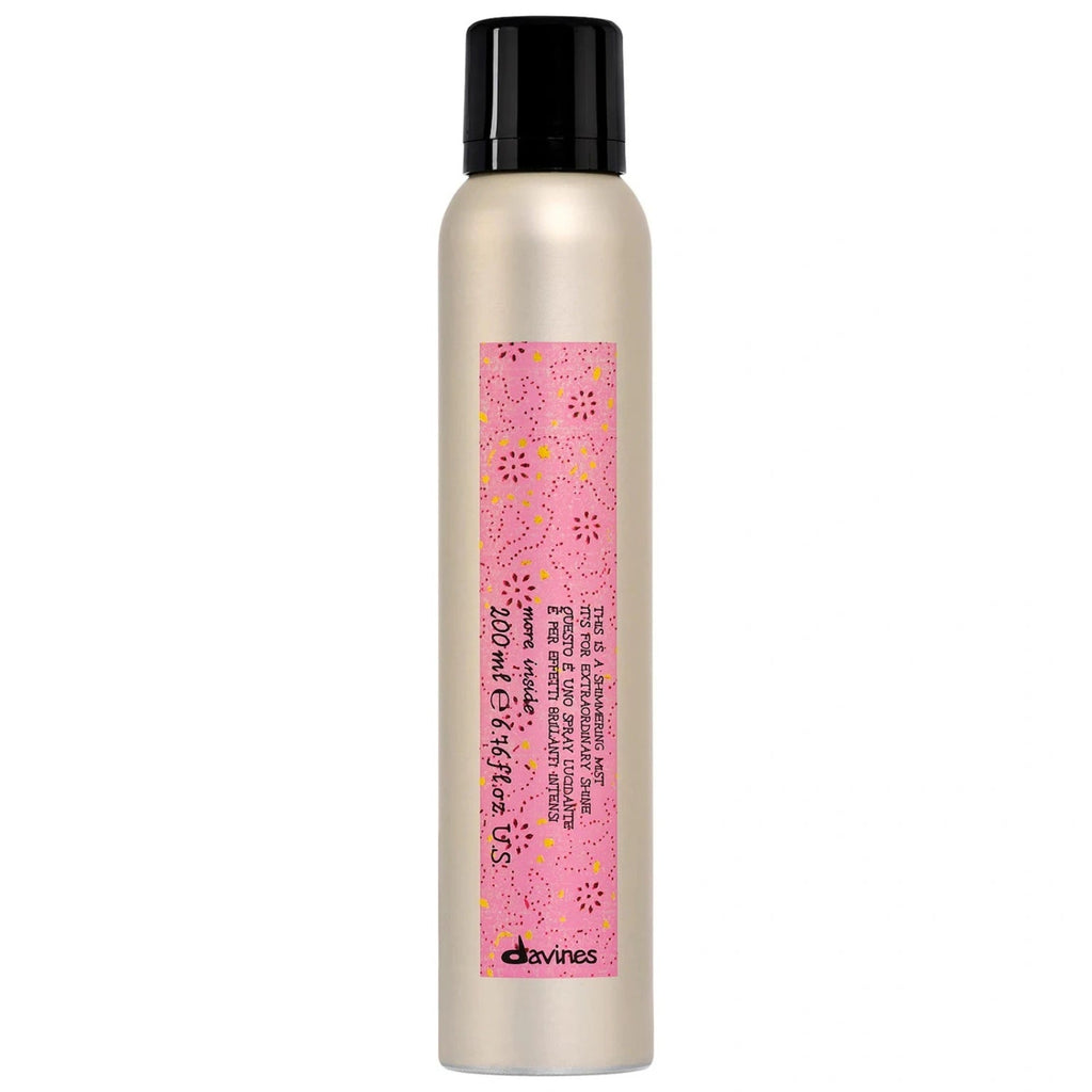 Davines shimmering mist bottle with black cap, metallic gold finish and pink label