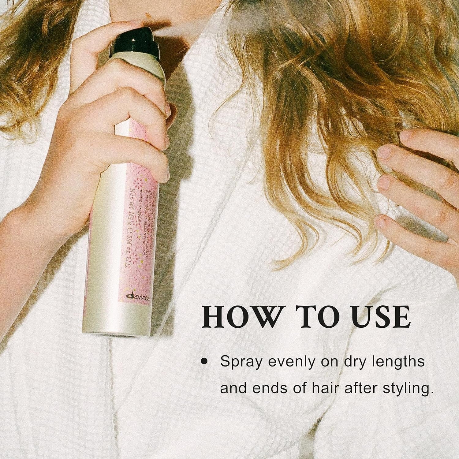 Davines shimmering mist spray bottle in white and pink with black cap