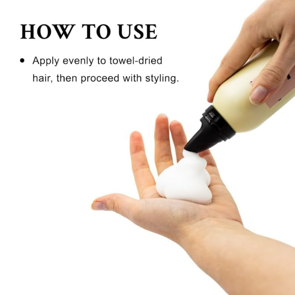 Hair volume boosting mousse application, hand holding beige bottle with black nozzle