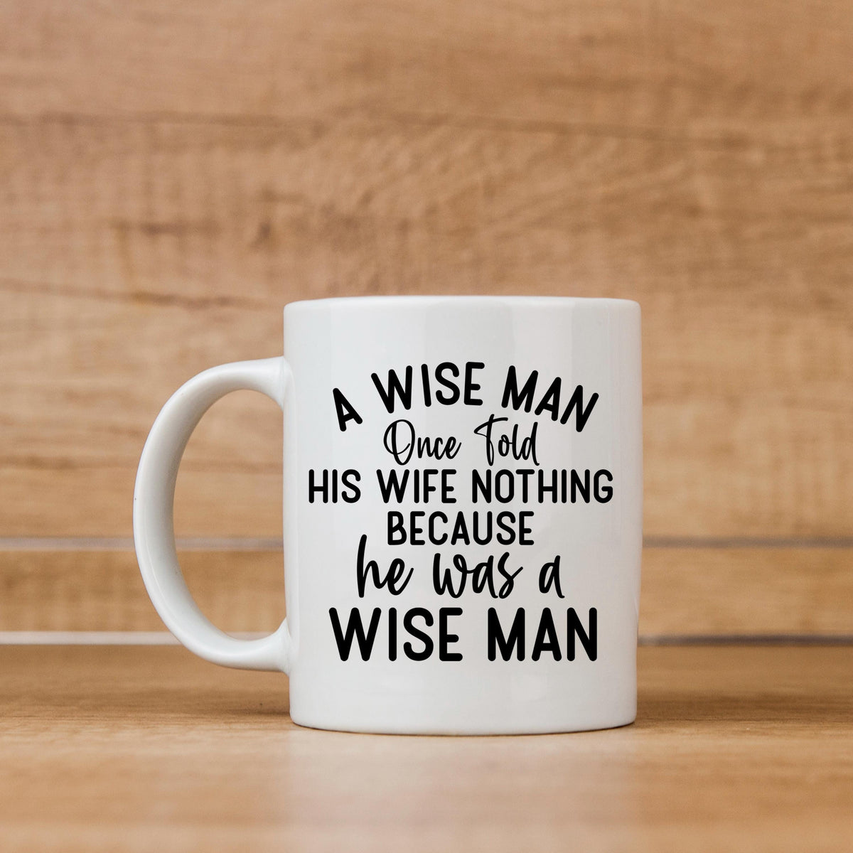 White ceramic coffee mug with "A WISE MAN" quote printed on the front